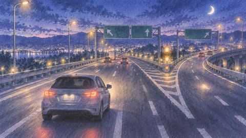 夜の高速道路で分岐を前に迷う車