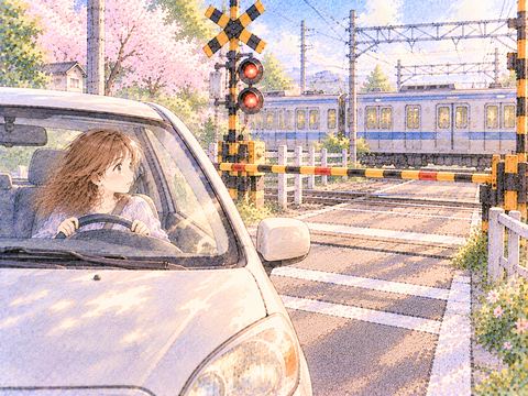 遮断機の手前で車を停め安全を確かめる女性